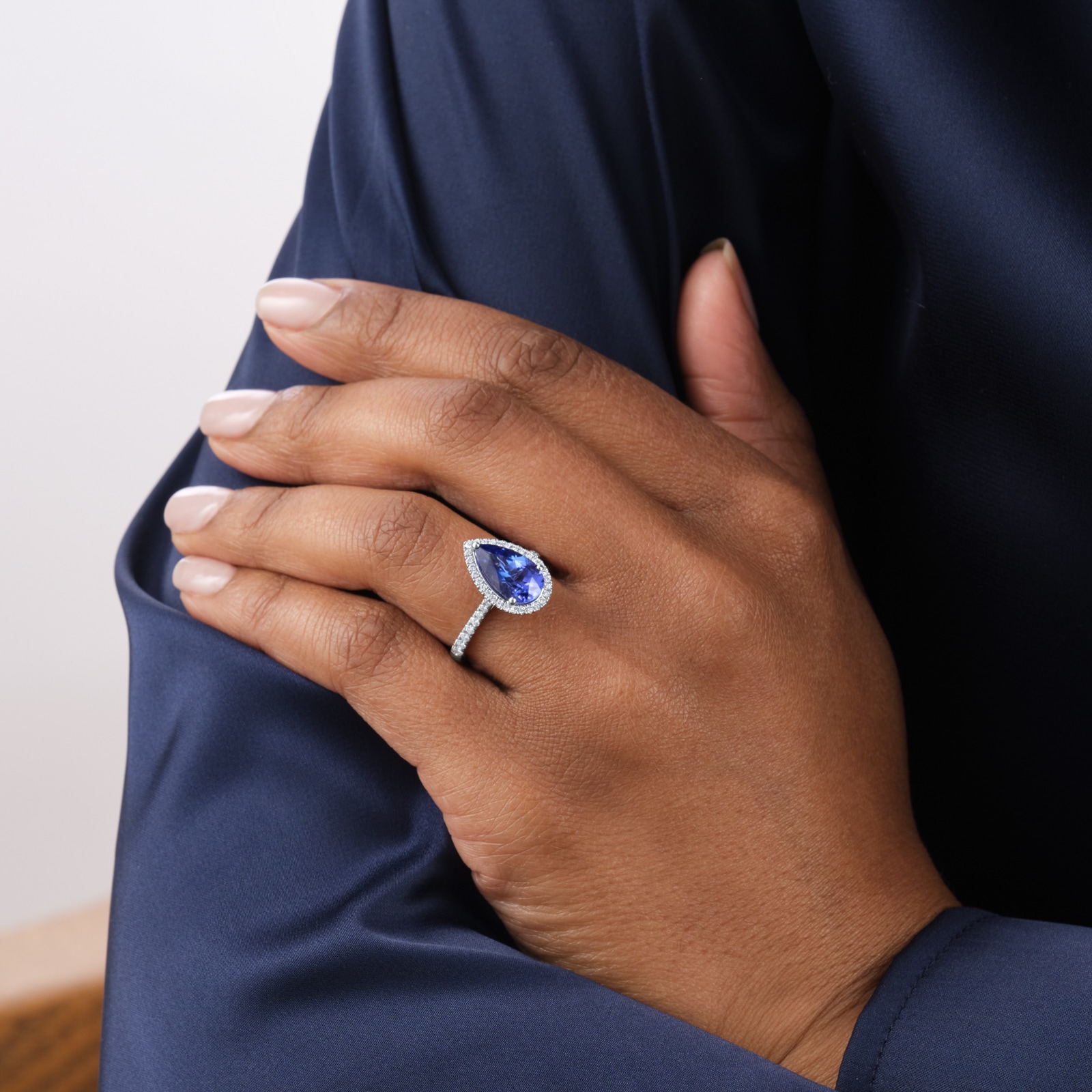 Goldsmiths Platinum Pear Cut Tanzanite and 0.33cttw Diamond Halo Ring