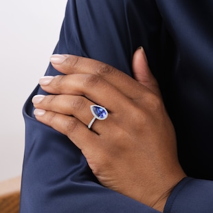 Goldsmiths Platinum Pear Cut Tanzanite and 0.33cttw Diamond Halo Ring