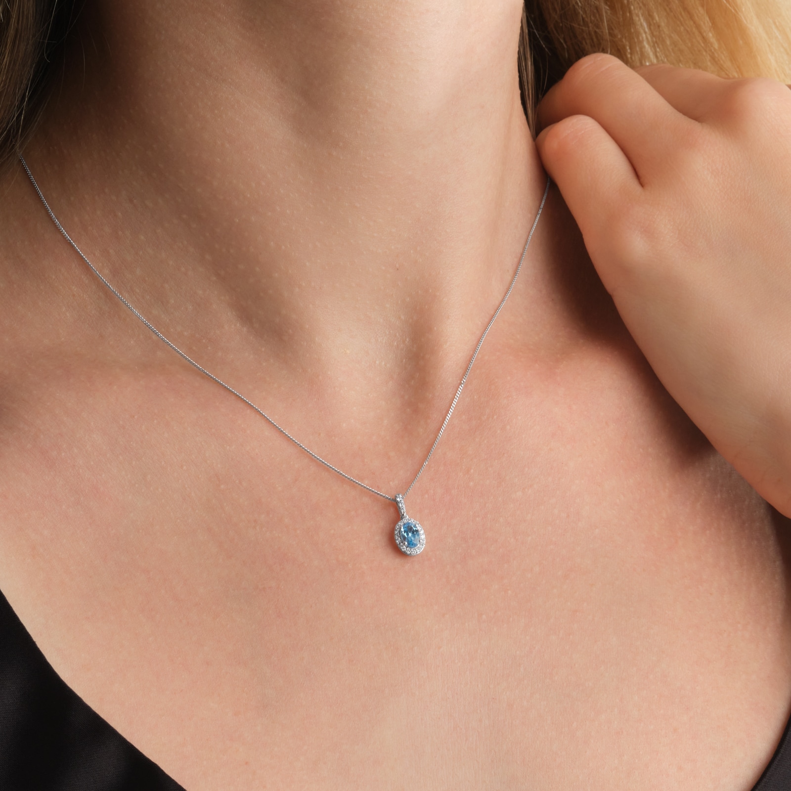 Goldsmiths 9ct White Gold Oval Blue Topaz and 0.10cttw Diamond Halo Pendant