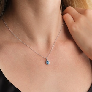 Goldsmiths 9ct White Gold Oval Blue Topaz and 0.10cttw Diamond Halo Pendant