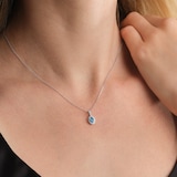 Goldsmiths 9ct White Gold Oval Blue Topaz and 0.10cttw Diamond Halo Pendant