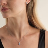 Goldsmiths 9ct White Gold Oval Blue Topaz and 0.10cttw Diamond Halo Pendant