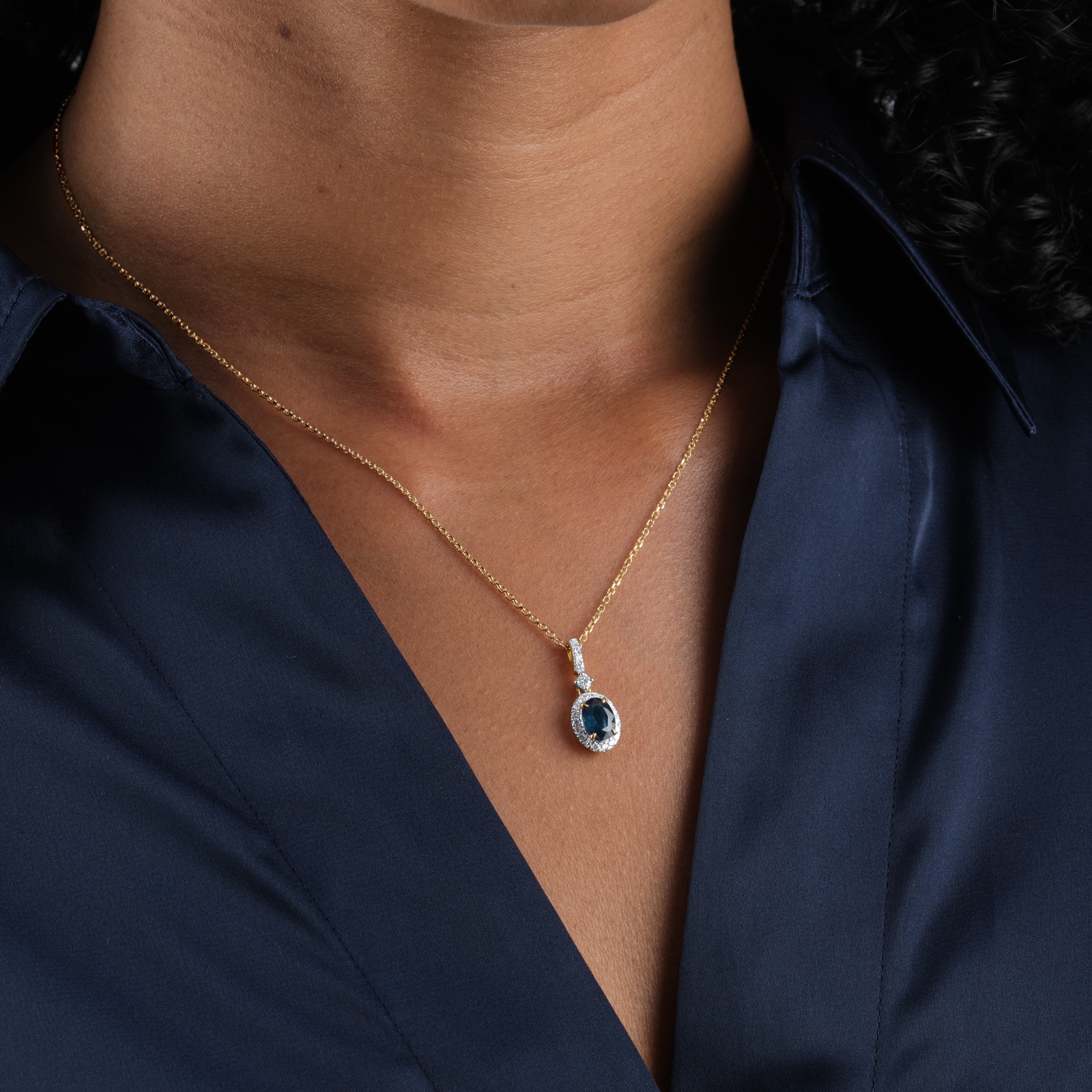Goldsmiths 18ct Yellow Gold Oval Cut Sapphire and Diamond Halo Pendant