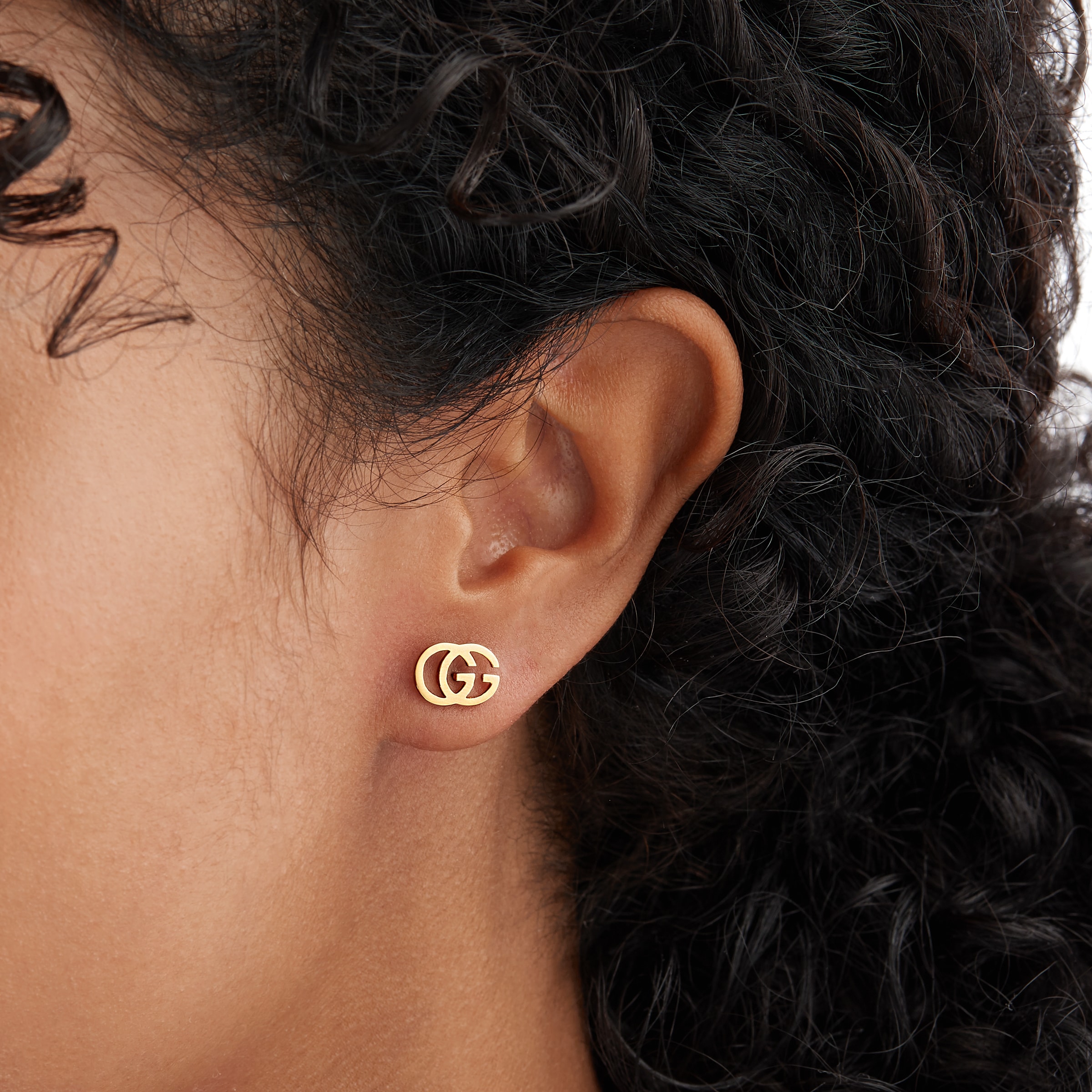 Gucci Interlocking hoop earrings in yellow gold-toned metal | GUCCI® US
