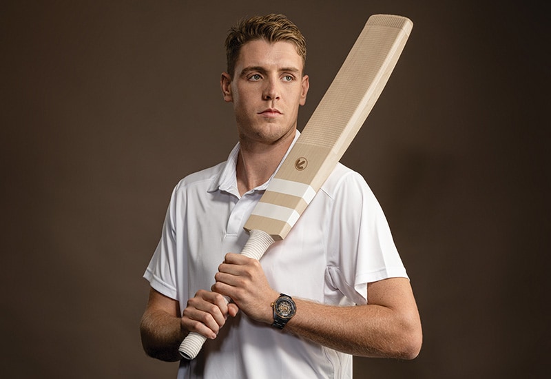 Image of Cameron Green holding cricket bat and wearing a Rado watch